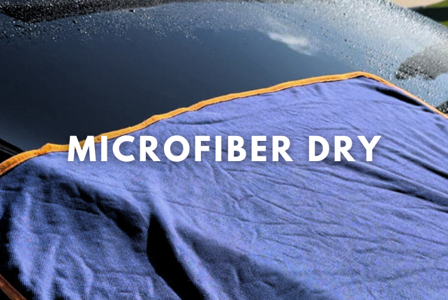 Step 3: Using a microfiber towel to gently dry a car after washing for a streak-free finish.