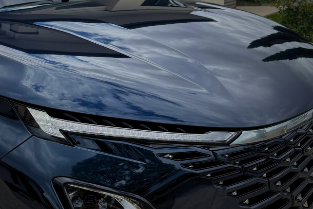 Application of ceramic coating on Chery car for a glossy finish and protection from rock chips and environmental damage.