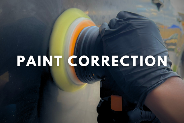 Performing paint correction on a car to remove scratches and restore a flawless finish.