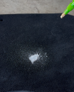 Cleaning solution applied to car carpet in Truganina to prepare for stain removal, servicing car owners near Point Cook.